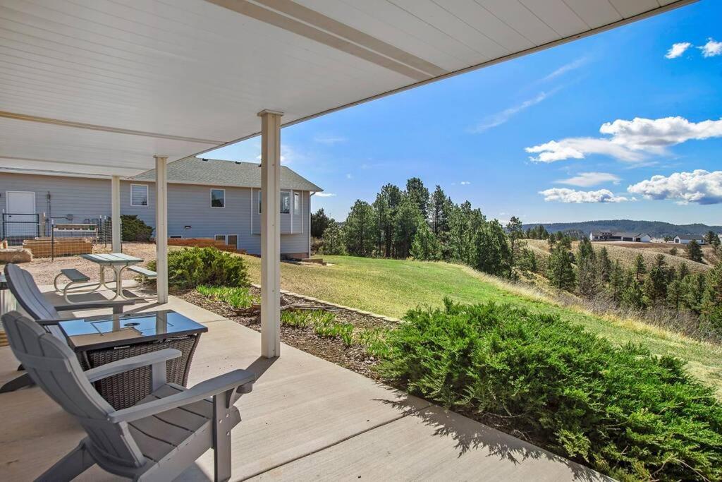 a patio with a table and chairs on a porch at Unique Barn Stay Close to The Hills in Rapid City