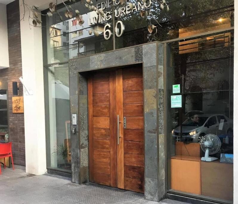 a store front with a wooden door on a building at Departamento Tipo Estudio / 1 Ambiente in Santiago