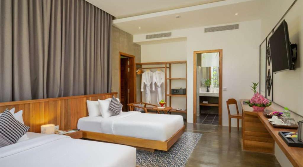 Postel nebo postele na pokoji v ubytování Phka Chan Hotel