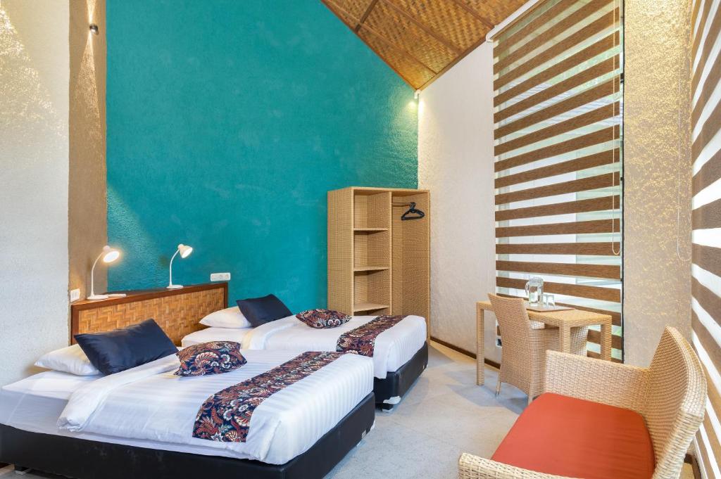 Postel nebo postele na pokoji v ubytování Thalassa Dive & Wellbeing Resort Manado