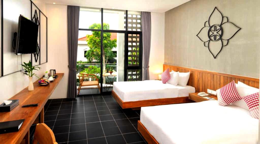 Postel nebo postele na pokoji v ubytování Phka Chan Hotel