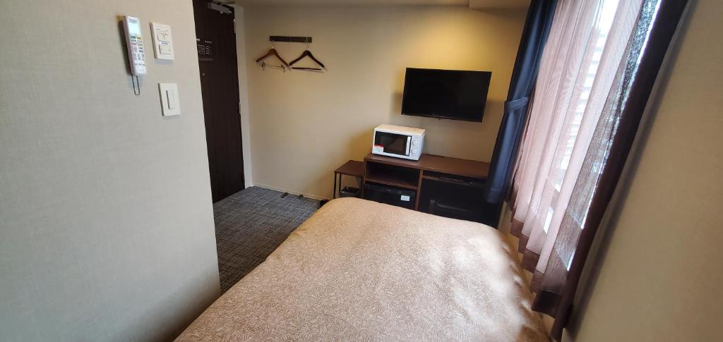 TV a/nebo společenská místnost v ubytování HOTEL LiVEMAX Kamata Ekimae