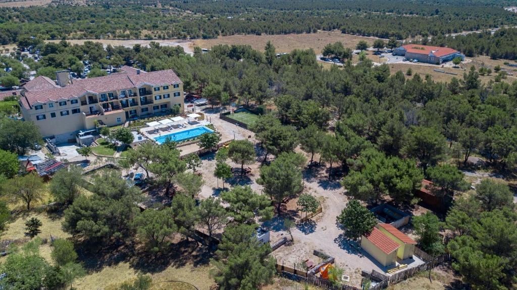 an aerial view of a house with a pool and trees at Camping Vrata Krke in Lozovac