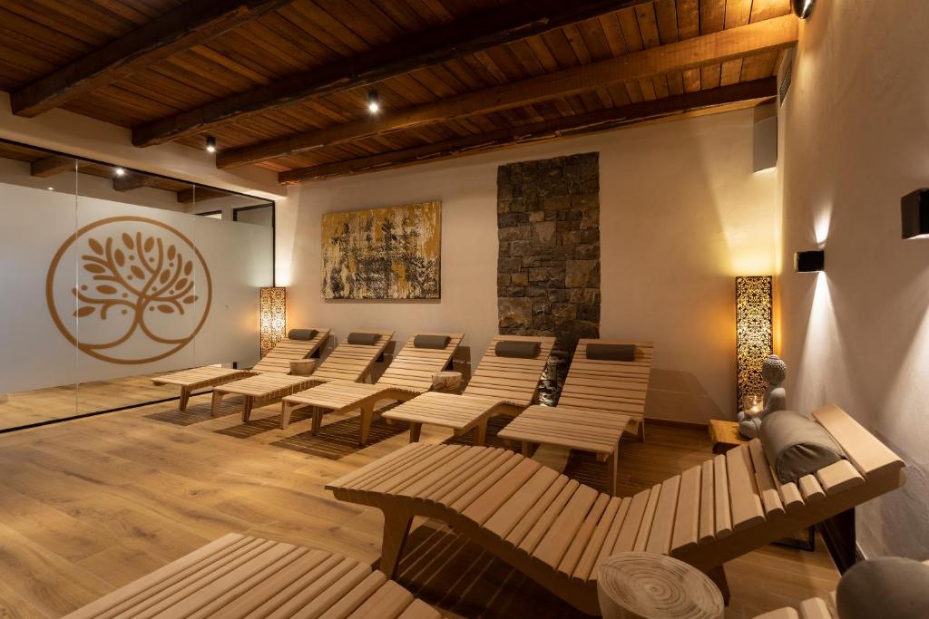 a room with rows of chairs and a painting on the wall at Guest House Valentincic in Nova Gorica