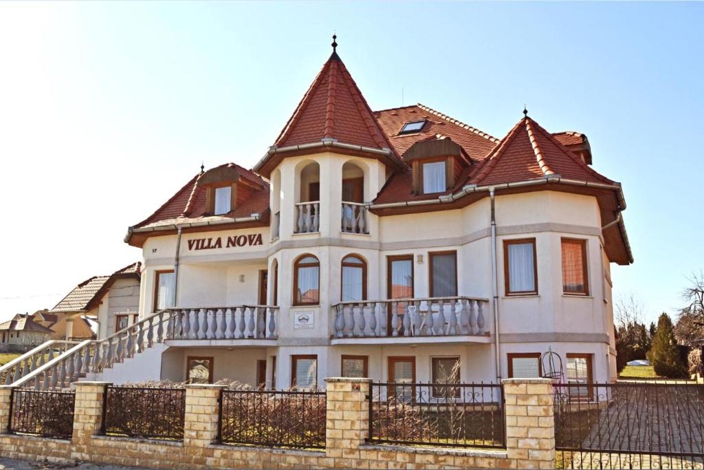 a large white house with a roof at Villa Nova in Hévíz