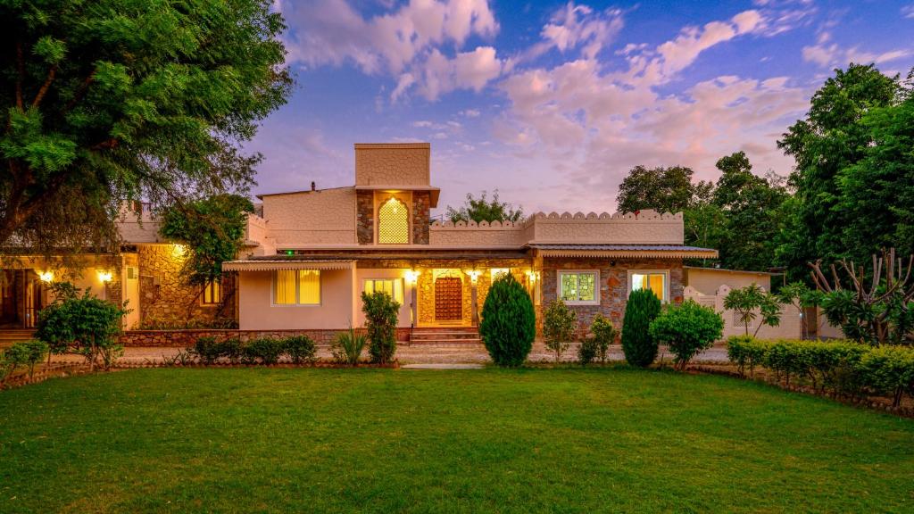 a house with a lawn in front of it at The Bagheera Heritage, Jaipur in Jaipur