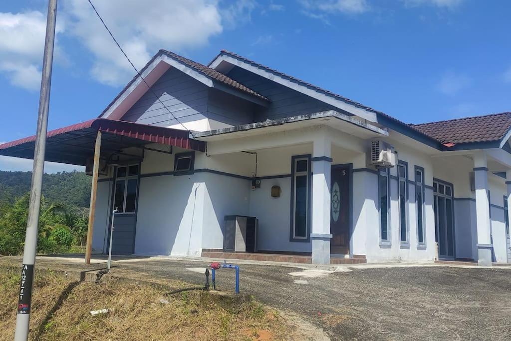 a house with a blue and white at Azhar Homestay in Jitra