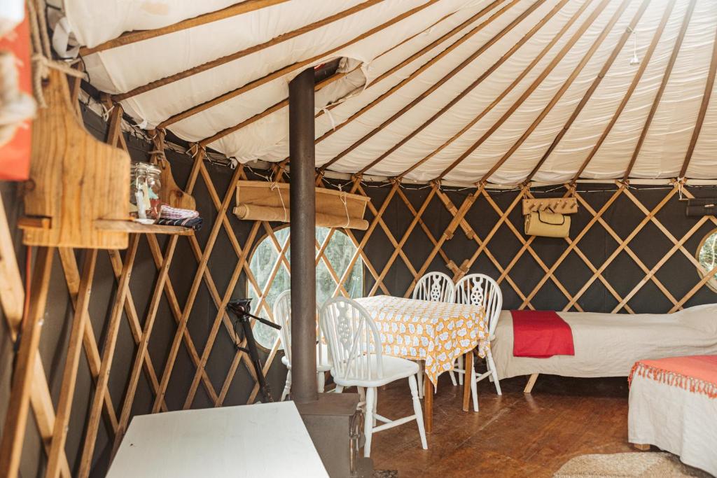 a room with chairs and a table in a yurt at Beech Yurt in Fernhurst