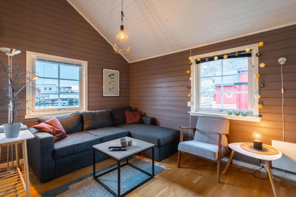 a living room with a couch and a table at Authentic Lofoten Rorbu in Stamsund
