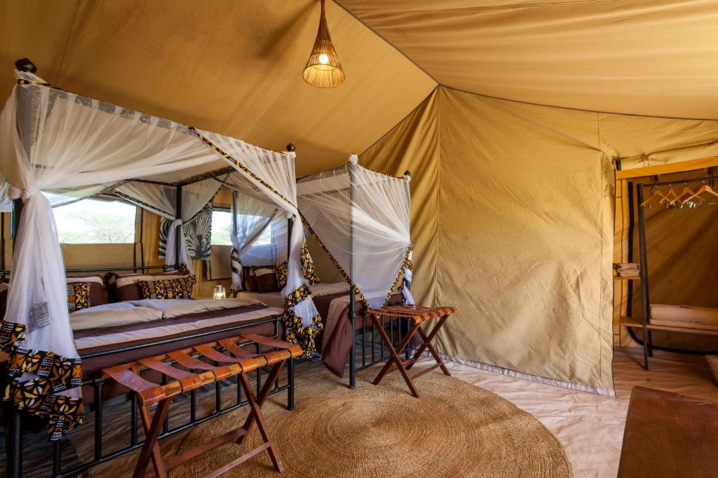 Postel nebo postele na pokoji v ubytování Gnu Ndutu Camp