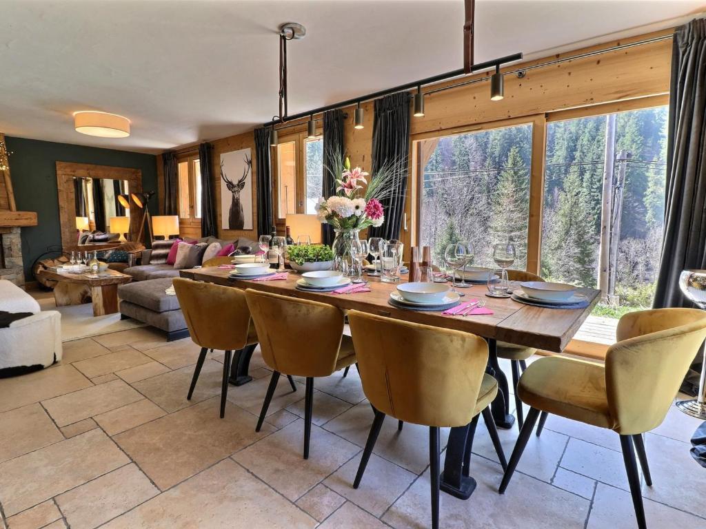 a dining room with a large wooden table and chairs at Chalet Morzine, 7 pièces, 8 personnes - FR-1-627-23 in Morzine