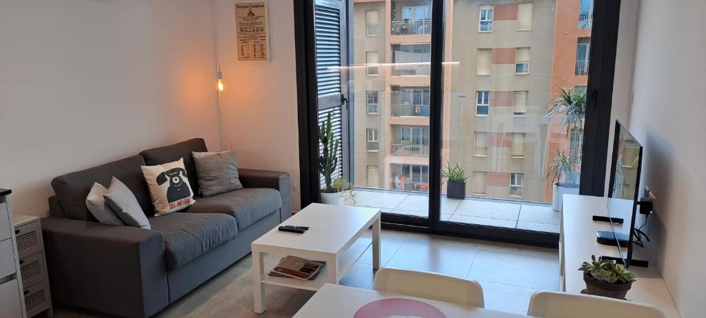 a living room with a couch and a large window at Large Studio with view-Hosted by Sweetstay in Gibraltar