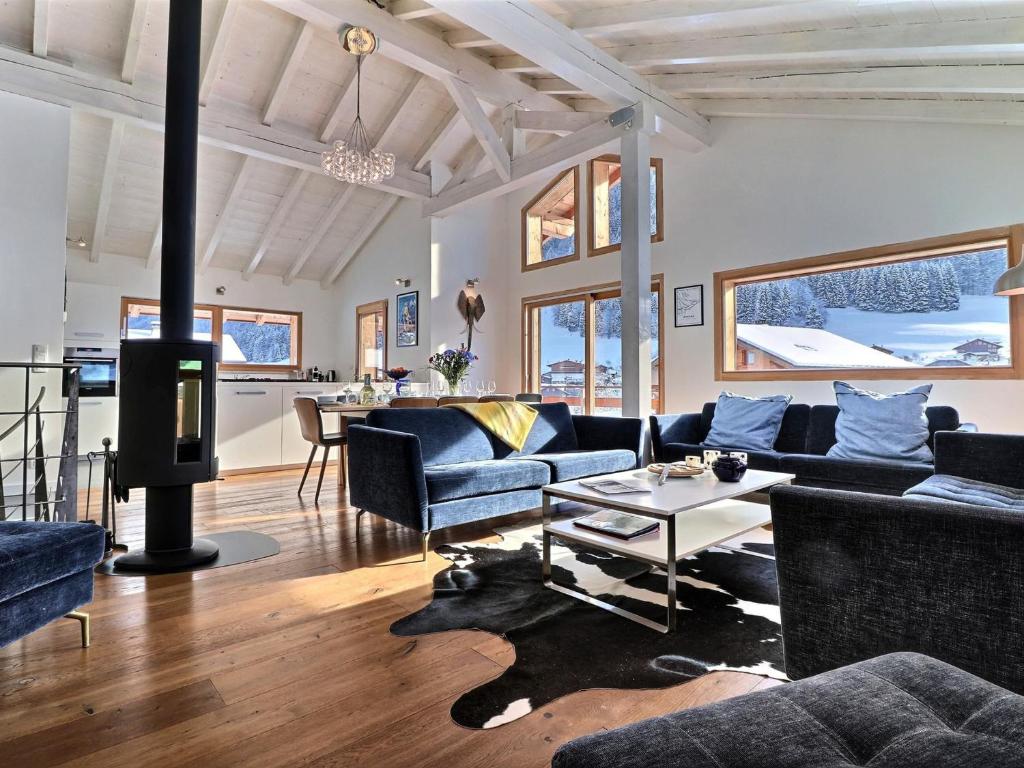 a living room with a couch and a table at Chalet Morzine, 6 pièces, 10 personnes - FR-1-627-24 in Morzine