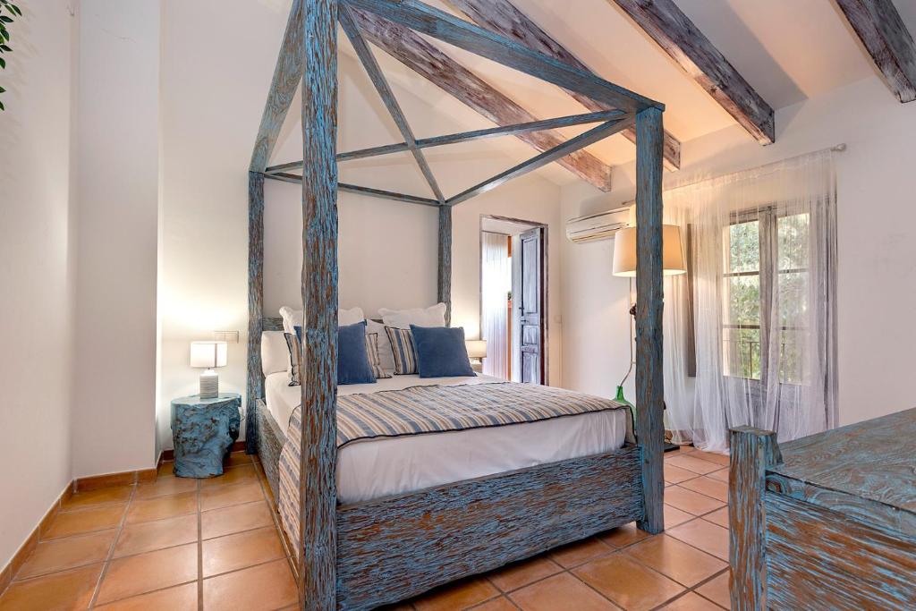 a bedroom with a canopy bed in a room at Villa Nice Mallorca in Palma de Mallorca