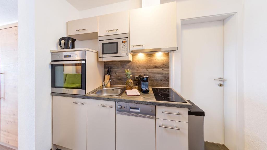 A kitchen or kitchenette at BIRKENHOF premium apart & suites