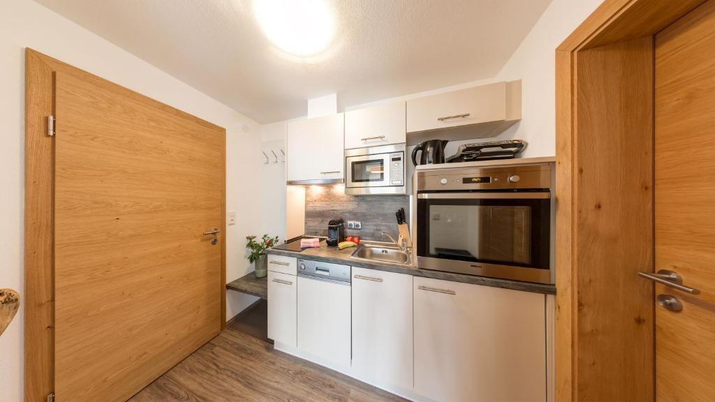 A kitchen or kitchenette at BIRKENHOF premium apart & suites