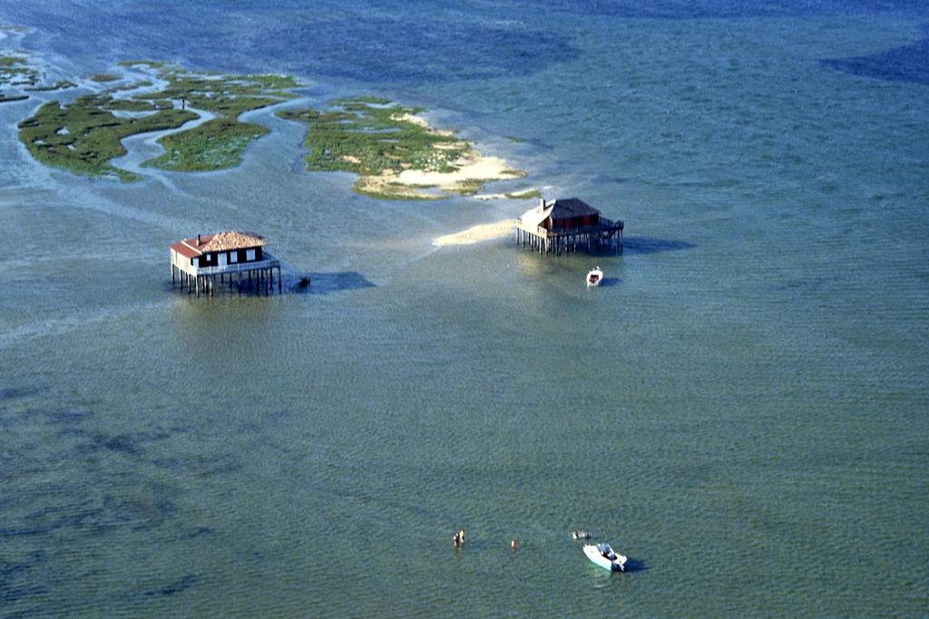 an aerial view of a group of islands in the water at La cabane du Truquet in Lège-Cap-Ferret