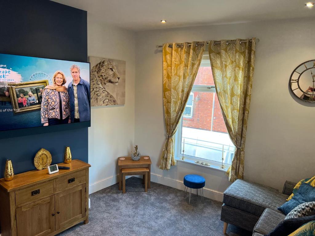 a living room with a couch and a large window at Luxury 2 bed Apartment in Stoke-on-Trent in Stoke on Trent