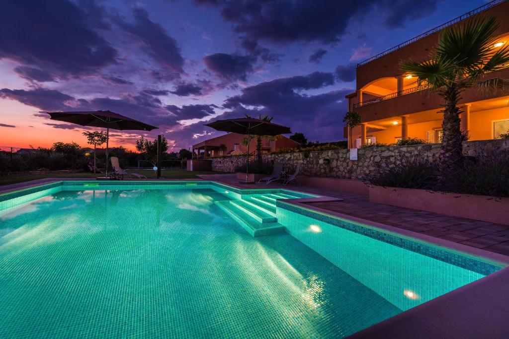 a swimming pool in front of a house at Apartment Alex 1 in Zadar