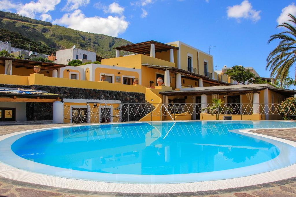 a large swimming pool in front of a house at Hotel Arcangelo - Salina in Santa Marina Salina