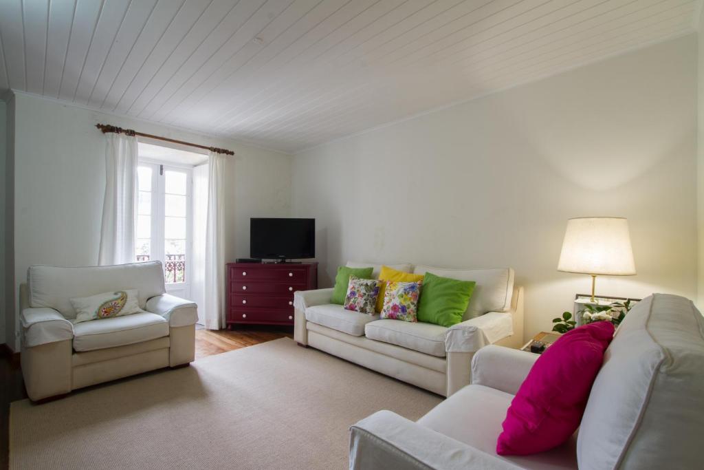 a living room with two couches and a tv at Casa da Avo in Furnas