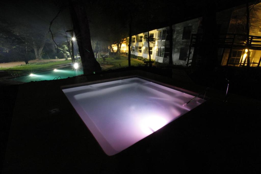 a lit up swimming pool in a dark room at Hotel Robledal in Las Trancas