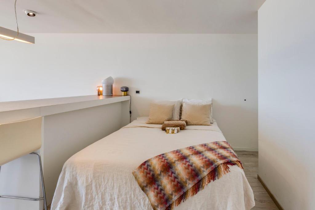 a small bedroom with a bed and a desk at Luxury Suite with Seaview in Ostend