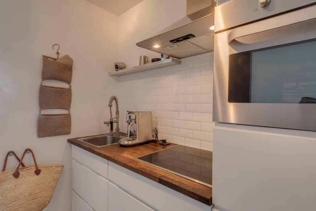 a kitchen with a sink and a microwave at Luxury Suite with Seaview in Ostend