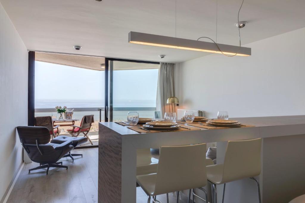 a kitchen and living room with a table and chairs at Luxury Suite with Seaview in Ostend