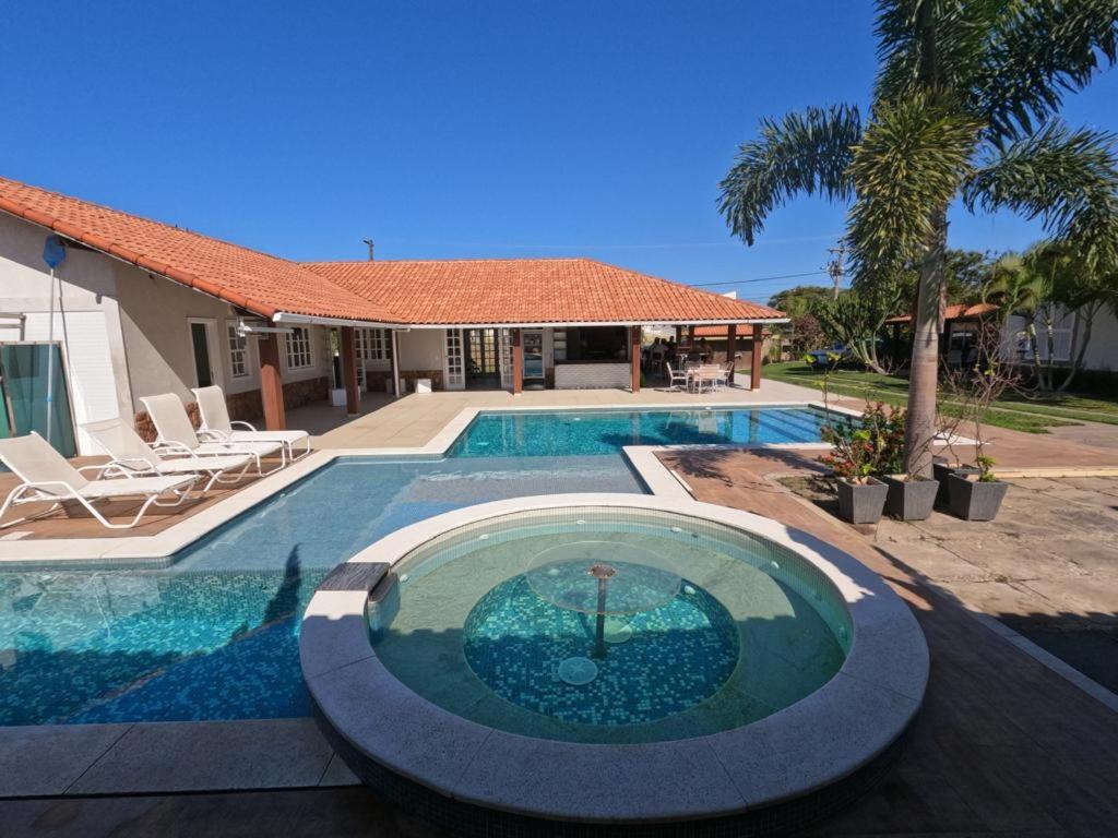 uma piscina em frente a uma casa em BIG HOUSE SAQUA em Saquarema