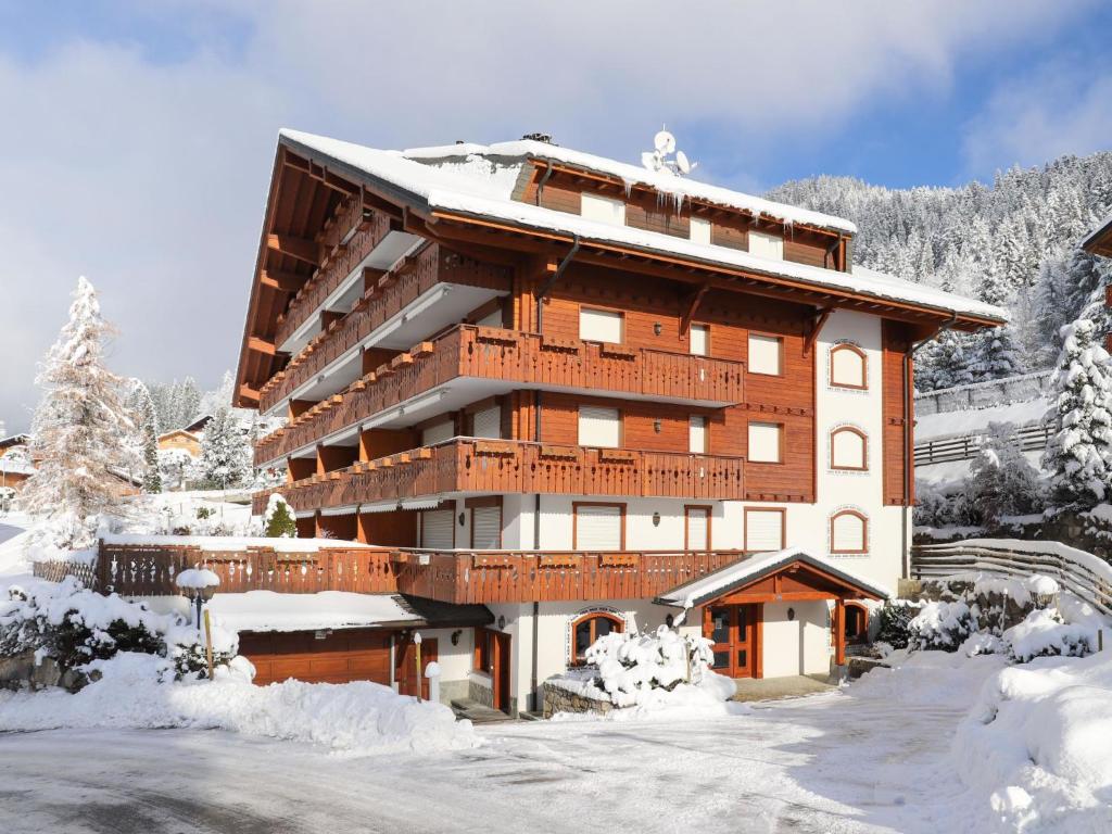 a large building with snow on the ground at Apartment Rhodonite 33 by Interhome in Villars-sur-Ollon