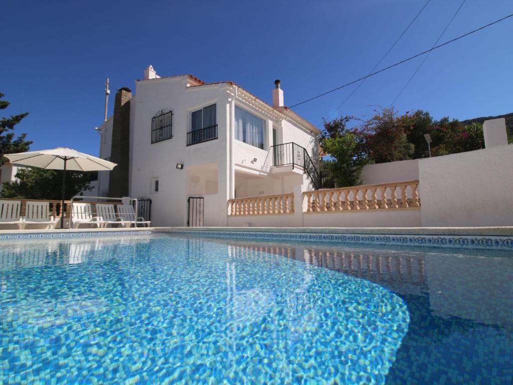 a villa with a swimming pool in front of a house at Holiday Home Tatiana by Interhome in La Canuta