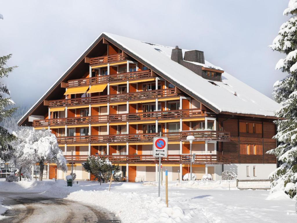 a large wooden building with snow on the ground at Apartment Opale 4 by Interhome in Villars-sur-Ollon