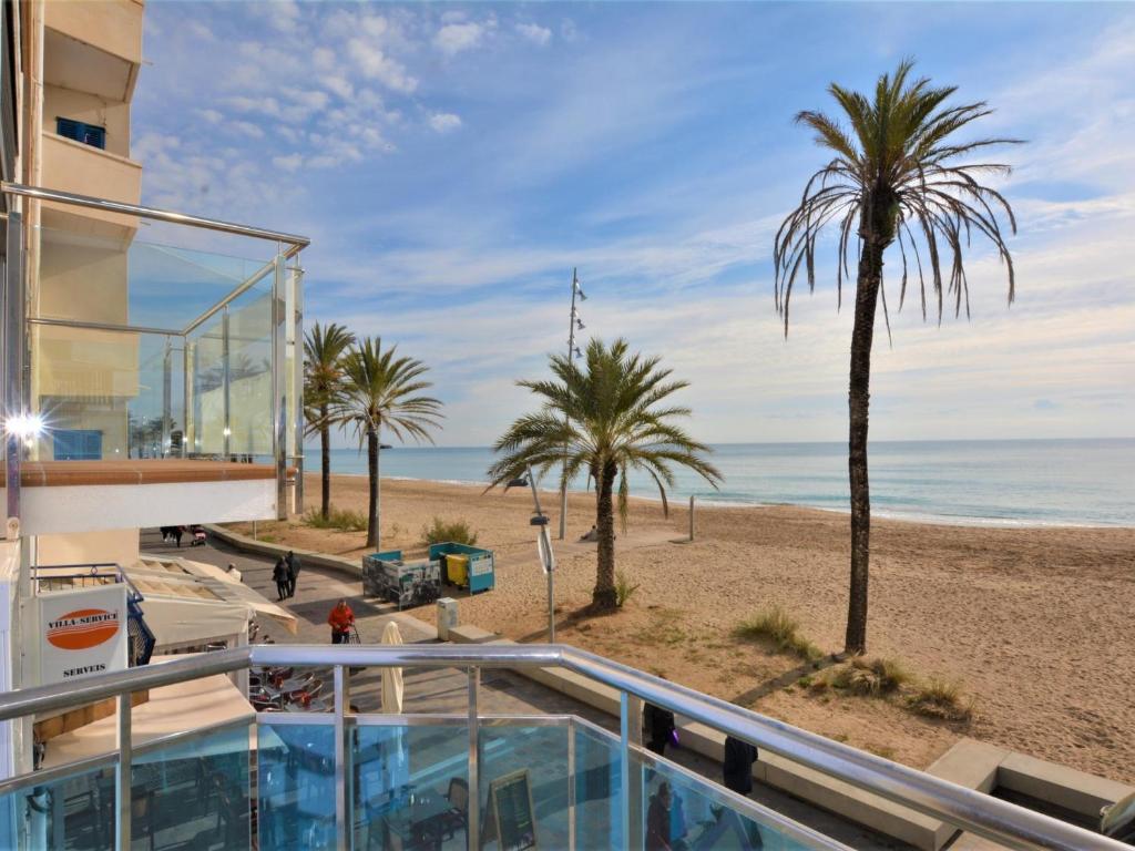 a view of the beach from the balcony of a house at Villa Service - Papiol 1º 2ª in Calafell