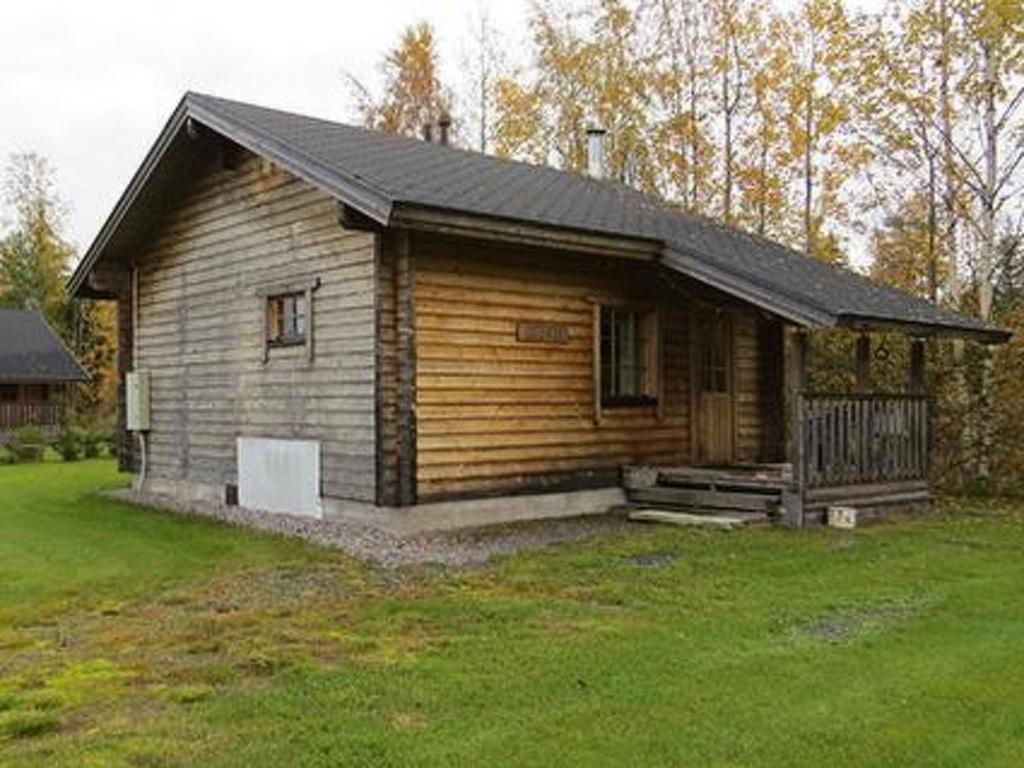eine kleine Holzhütte mit einer Veranda im Hof in der Unterkunft Holiday Home Uisku by Interhome in Punkalaidun