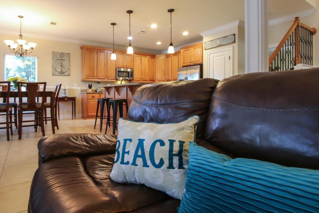 a brown leather couch in a living room at Amazing 4 Bedroom Vacation Home in The Villages of Crystal Lakes in Destin