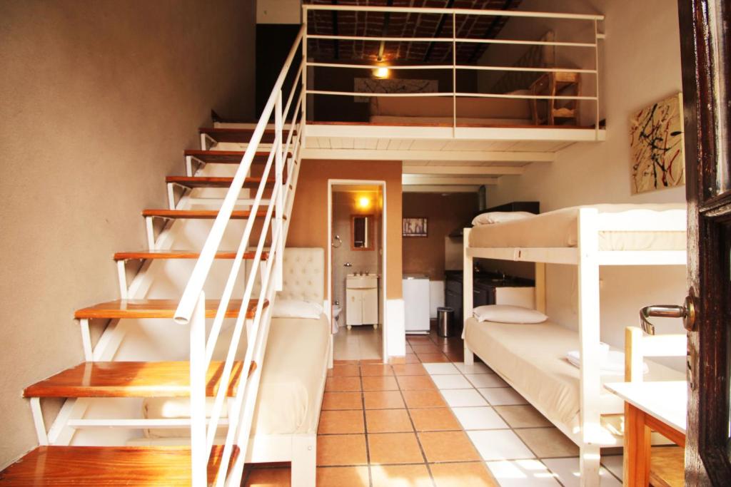 a dorm room with bunk beds and a staircase at Puerto Delta in Tigre