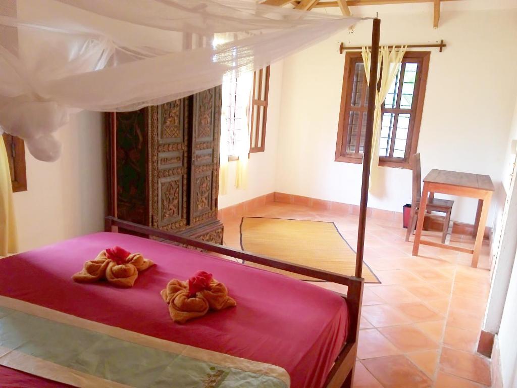 Postel nebo postele na pokoji v ubytování Arun Mekong Guesthouse