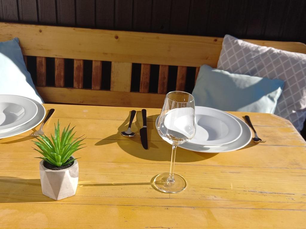 a wooden table with a plate and a wine glass at Apartment Hasennest by Interhome in Bad Hofgastein