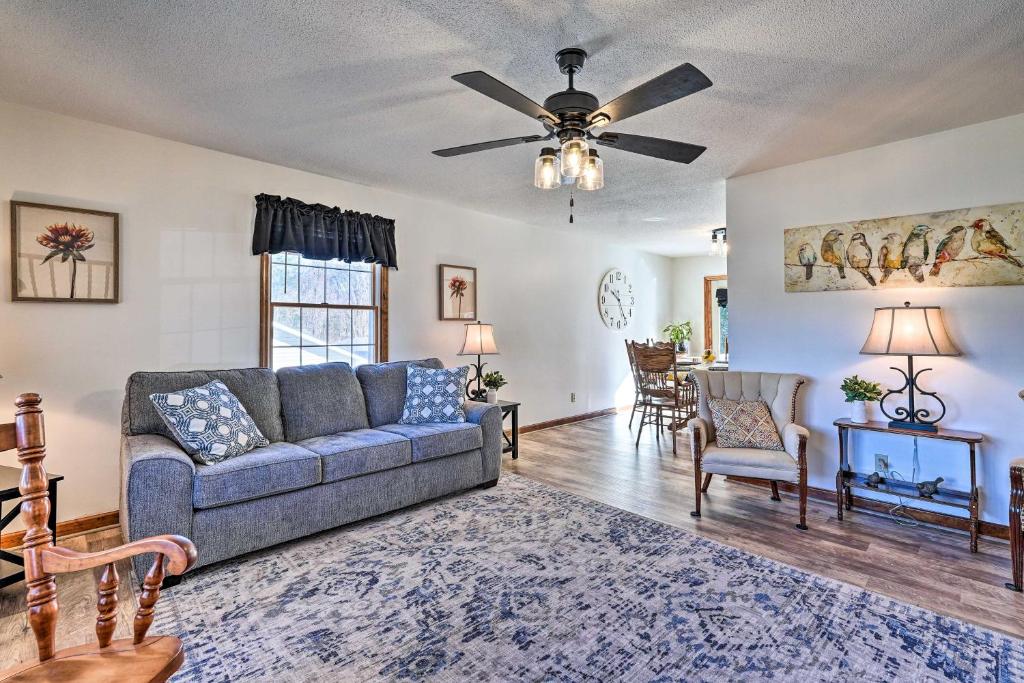 a living room with a couch and a ceiling fan at Cozy Vacation Rental Home Near Watauga Lake! in Elizabethton