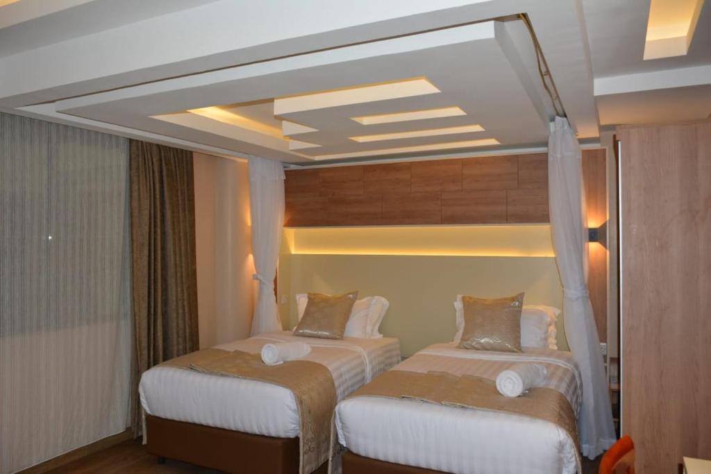 Postel nebo postele na pokoji v ubytování Hylise Hotel