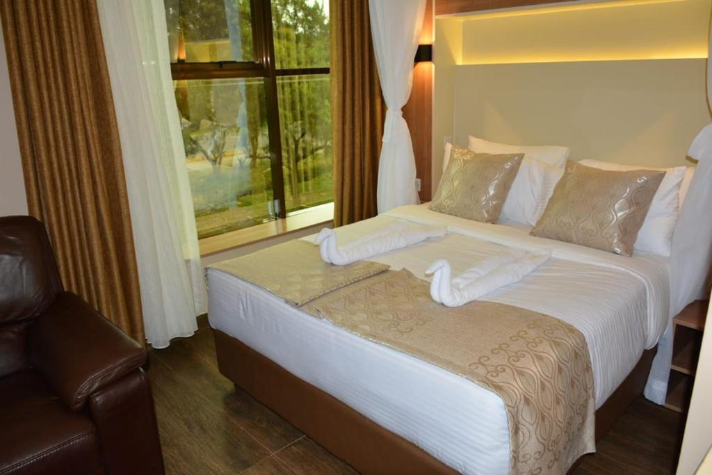 Postel nebo postele na pokoji v ubytování Hylise Hotel