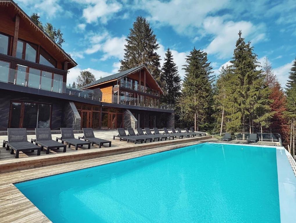 a house with a swimming pool on a deck at SevenHills chalet in Yablunytsya