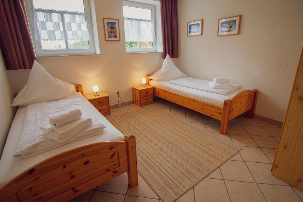 Postel nebo postele na pokoji v ubytování Haus Merlin - Austernfischer
