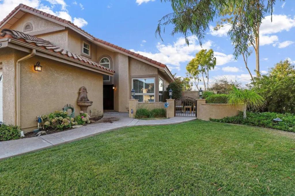 a house with a lawn in front of it at Casa Oasis/Pool & Jacuzzi/4 Bedroom/ Wi-Fi in Camarillo