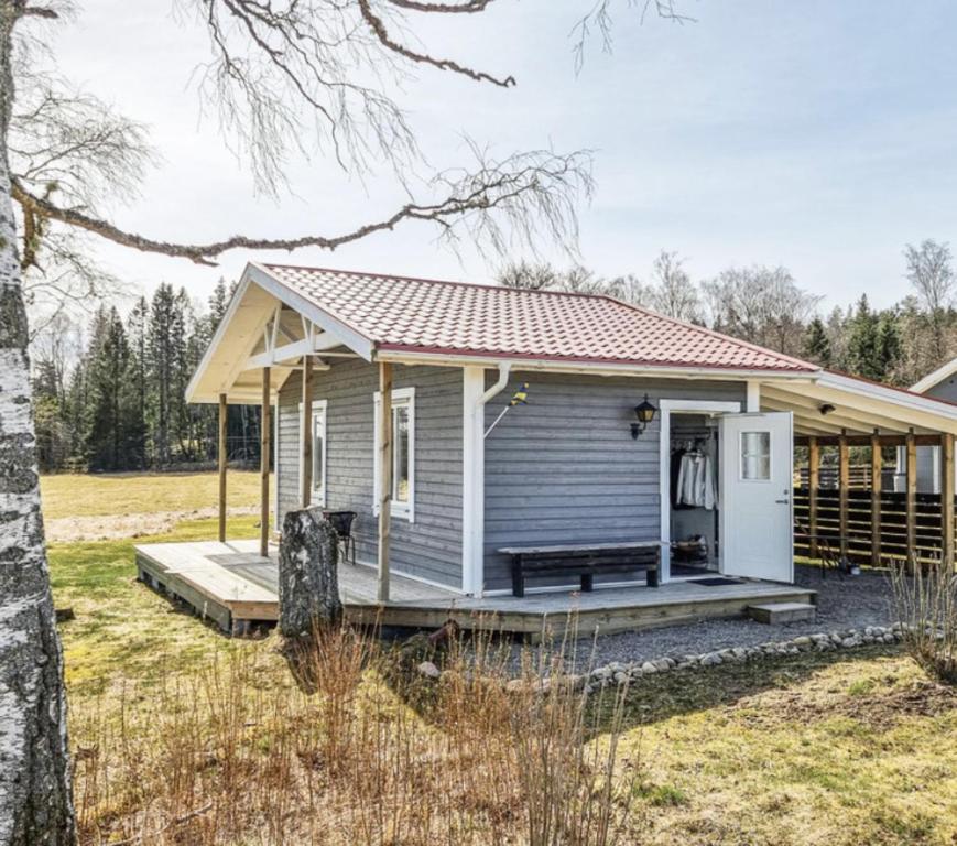 una casa pequeña con porche y terraza en Holiday house in Ljungskile, en Ljungskile