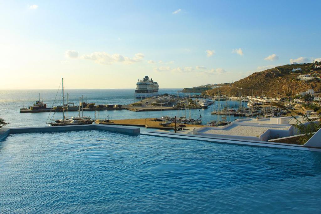 a swimming pool with a view of a marina at Calistus Mykonos in Mikonos