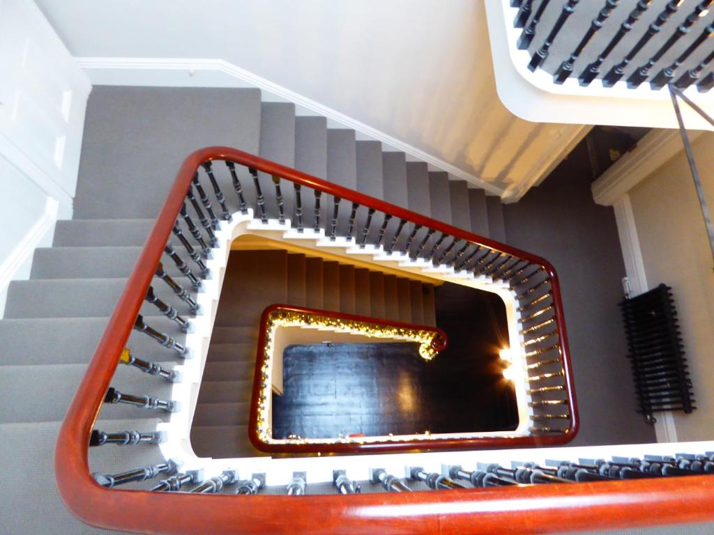 a set of stairs with a mirror on the wall at Number Nine Torquay in Torquay