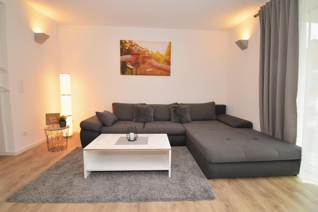 a living room with a couch and a coffee table at WINETIME - modern - für 5 - idyllisch - Netflix in Roschbach