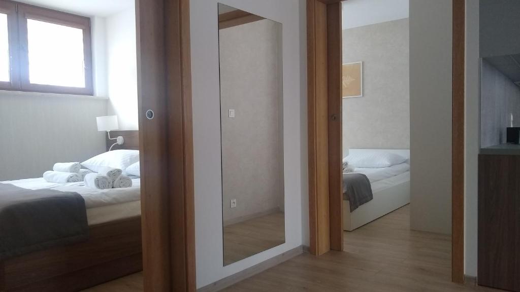 Postel nebo postele na pokoji v ubytování Apartamenty Leśne Zacisze